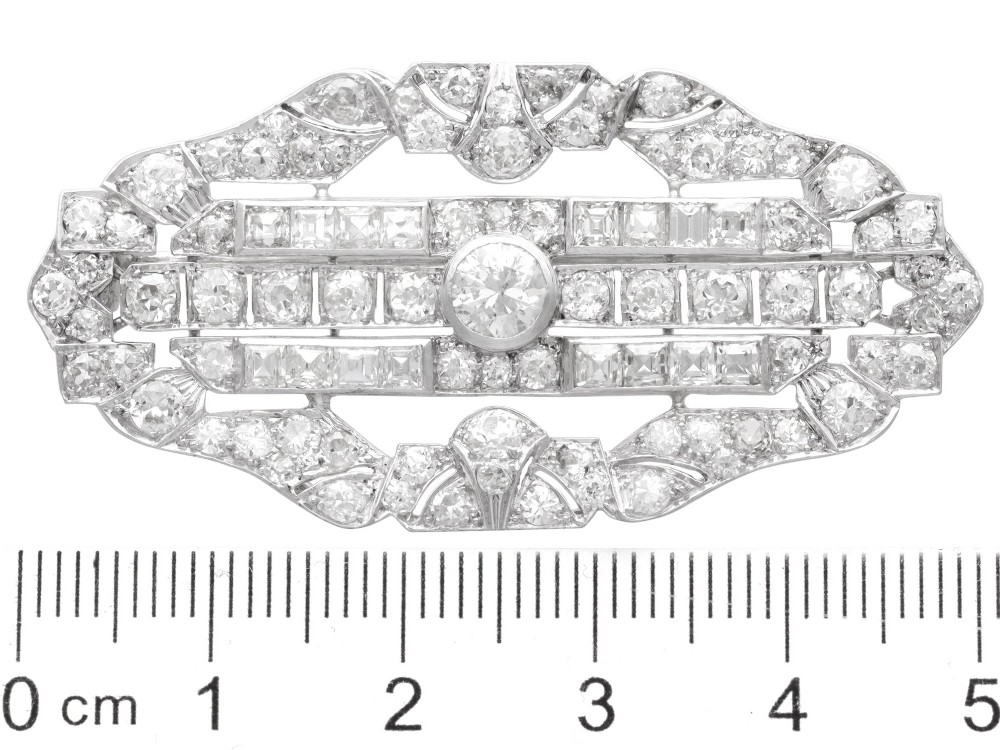 An Art Deco platinum brooch styled in an elongated geometric openwork plaque pattern, set throughout with brilliant and square-cut diamonds. View X