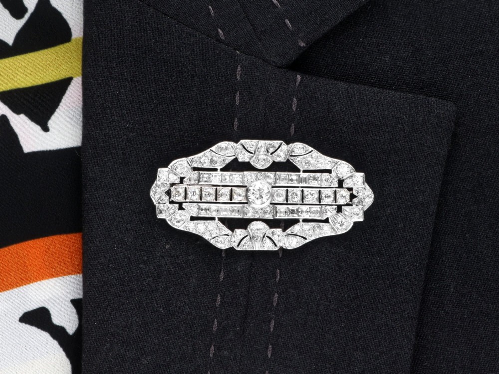 An Art Deco platinum brooch styled in an elongated geometric openwork plaque pattern, set throughout with brilliant and square-cut diamonds. View XI
