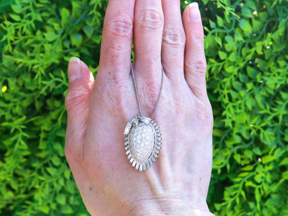 A 1950s vintage white gold organic pendant set with brilliant-cut diamonds and bordered by baguette-cut diamonds. View II