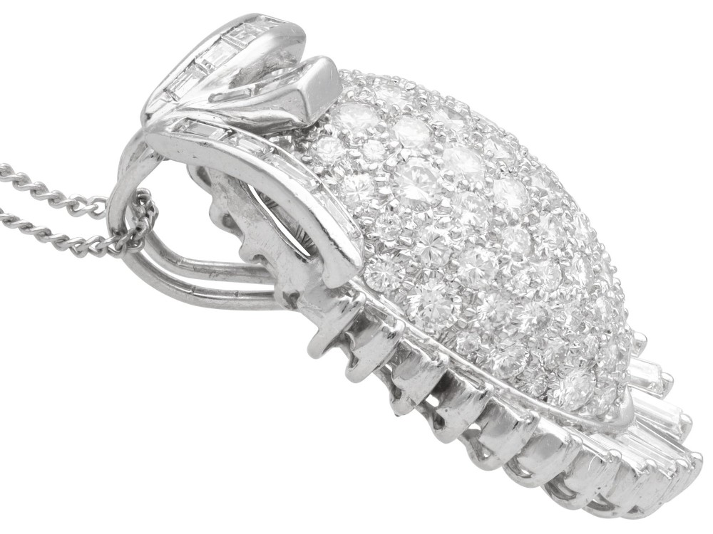 A 1950s vintage white gold organic pendant set with brilliant-cut diamonds and bordered by baguette-cut diamonds. View VIII