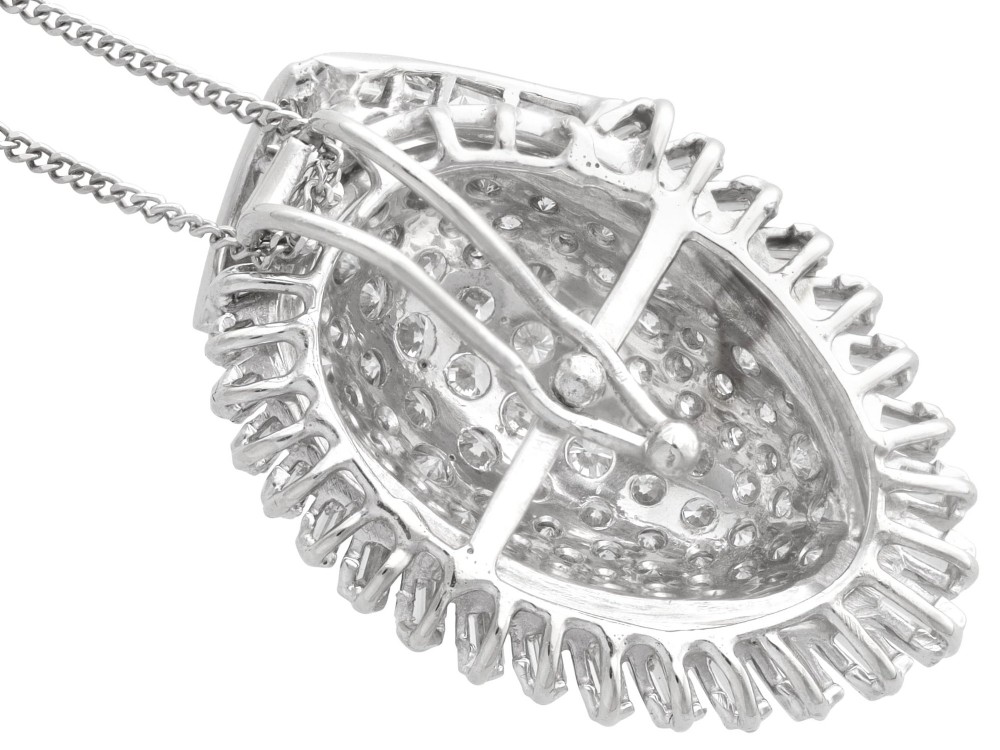 A 1950s vintage white gold organic pendant set with brilliant-cut diamonds and bordered by baguette-cut diamonds. View IX