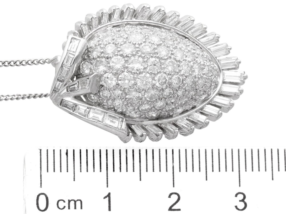 A 1950s vintage white gold organic pendant set with brilliant-cut diamonds and bordered by baguette-cut diamonds. View X