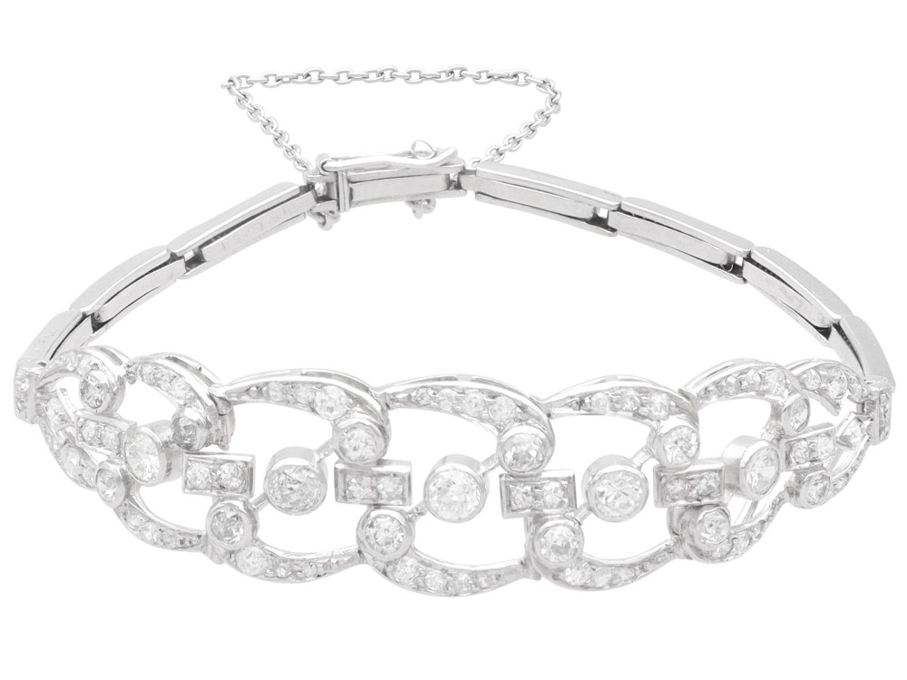 An Art Deco platinum bracelet featuring openwork geometric links set with round brilliant diamonds. View VI