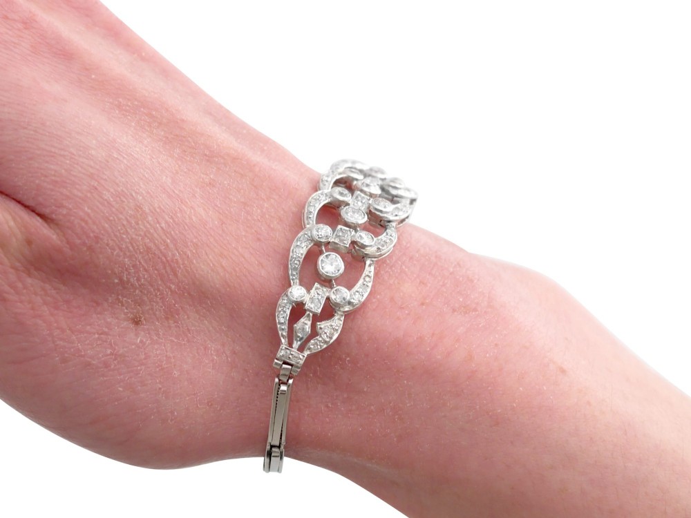 An Art Deco platinum bracelet featuring openwork geometric links set with round brilliant diamonds. View XII