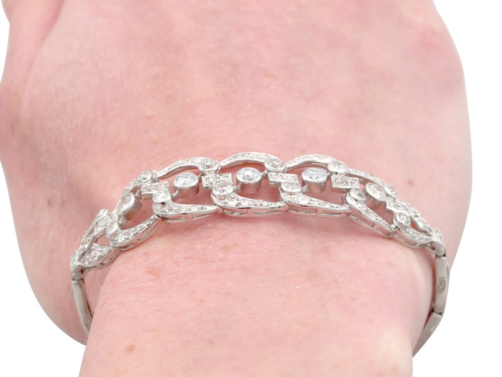 An Art Deco platinum bracelet featuring openwork geometric links set with round brilliant diamonds. View XIII