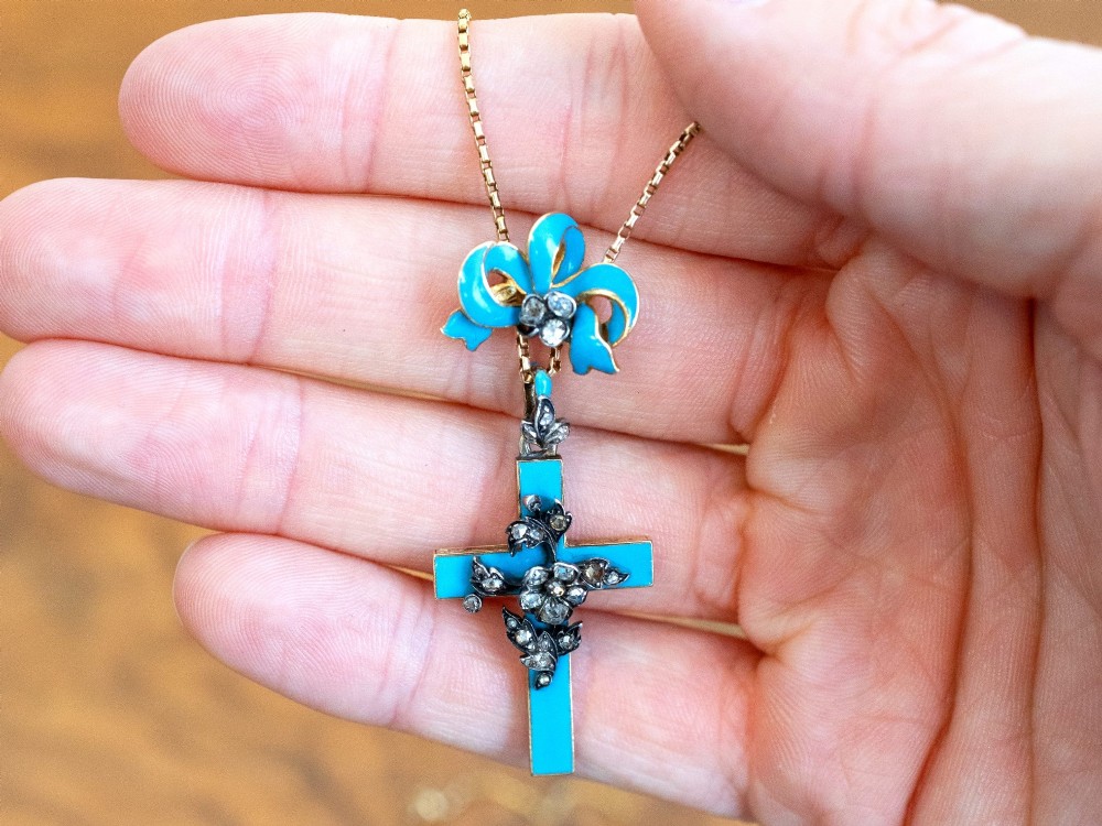 A Georgian 15ct yellow gold cross pendant featuring blue enamel, a diamond-set ribbon bow loop, and floral diamond overlays. View III