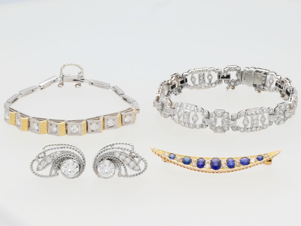 An antique late Victorian 9ct yellow gold crescent brooch set with graduated oval blue sapphires and accent diamonds. View V