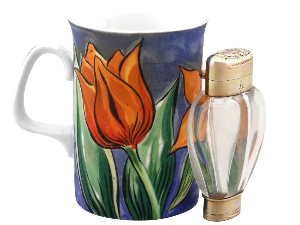 A Victorian clear glass scent bottle with fluted sides and engraved sterling silver caps at the top and base. View XV