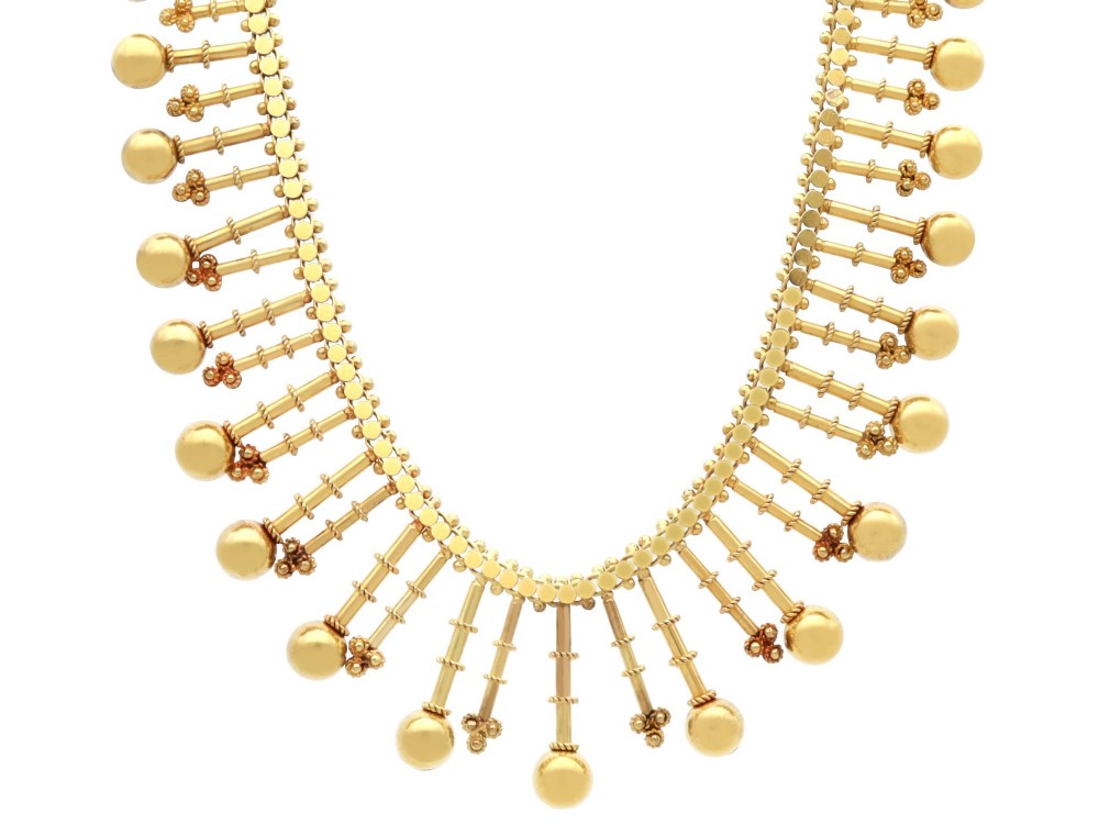 An antique 18ct yellow gold Victorian fringe necklace featuring articulated drop elements with spherical ball terminals and beaded details.