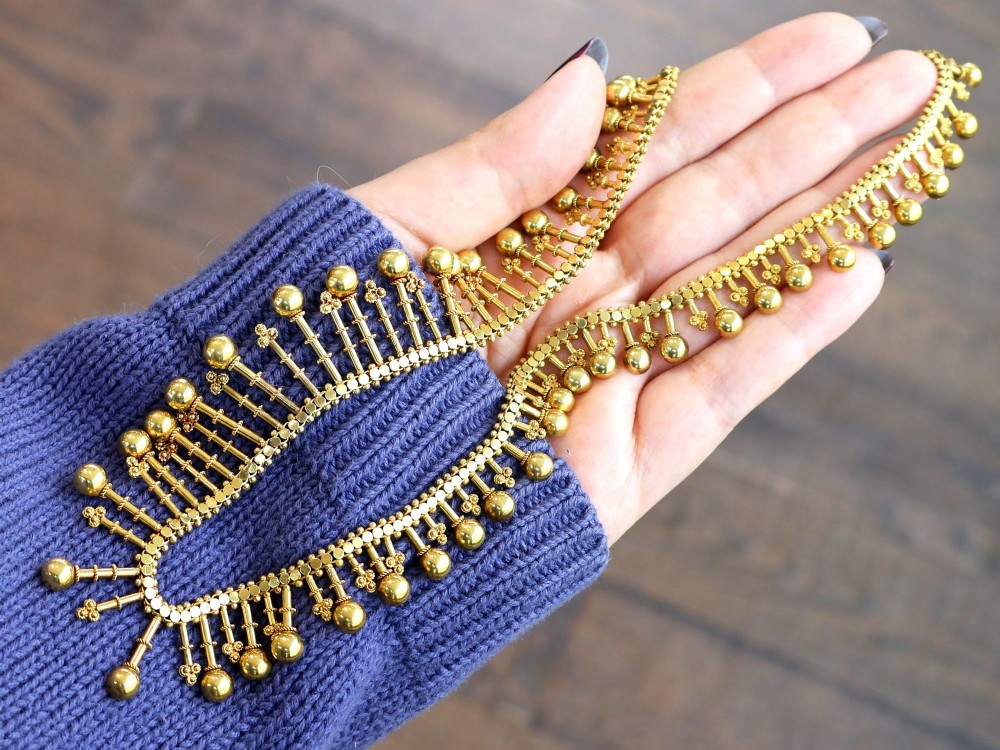 An antique 18ct yellow gold Victorian fringe necklace featuring articulated drop elements with spherical ball terminals and beaded details. View IV
