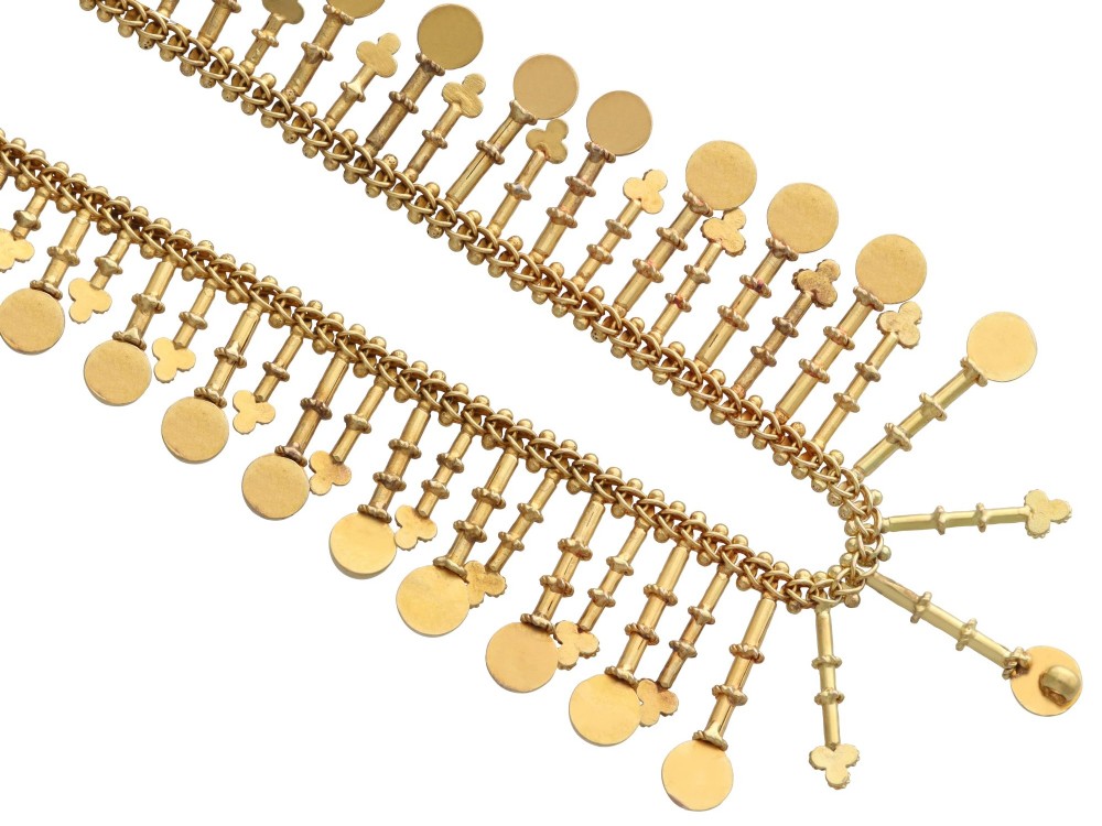 An antique 18ct yellow gold Victorian fringe necklace featuring articulated drop elements with spherical ball terminals and beaded details. View X