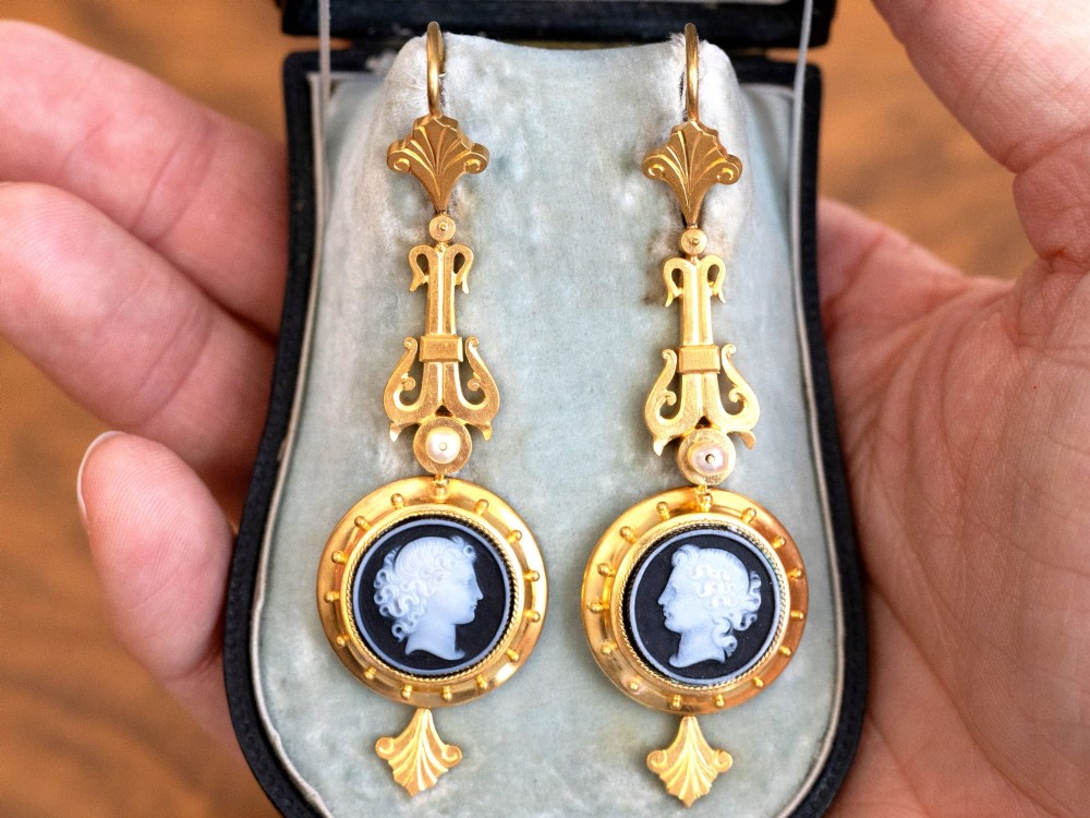 A pair of late Victorian 22ct yellow gold drop earrings featuring hand-carved hardstone cameo profile portraits and small seed pearls. View IV