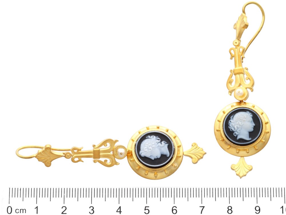 A pair of late Victorian 22ct yellow gold drop earrings featuring hand-carved hardstone cameo profile portraits and small seed pearls. View IX