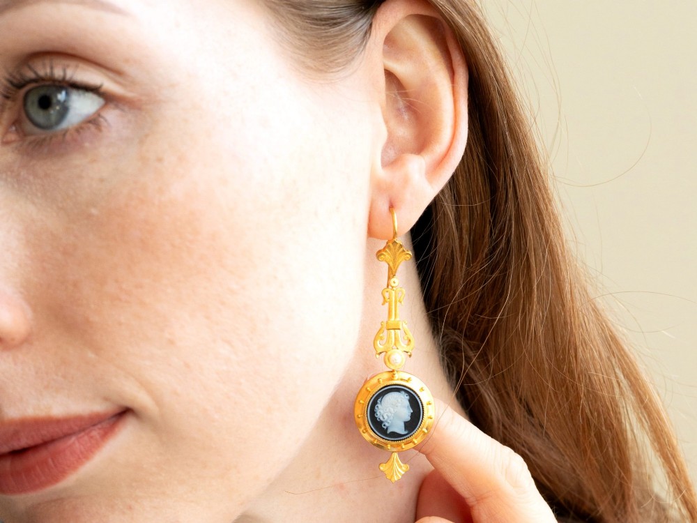 A pair of late Victorian 22ct yellow gold drop earrings featuring hand-carved hardstone cameo profile portraits and small seed pearls. View XIII