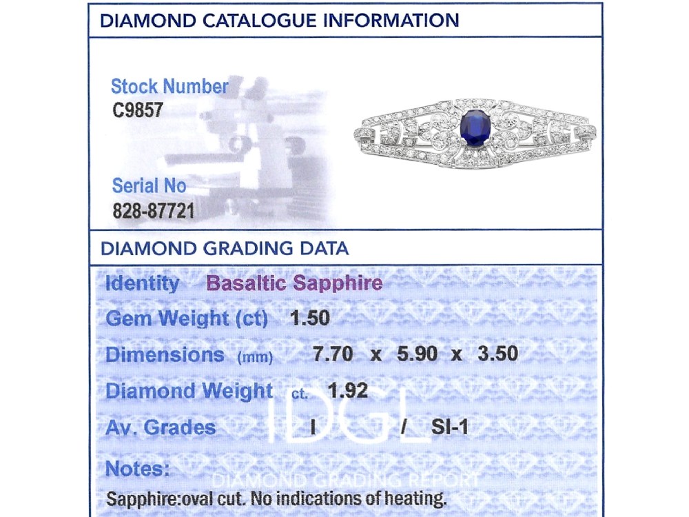 An Art Deco 9ct white gold brooch featuring a central oval blue sapphire framed by geometric openwork set with round diamonds. View XI