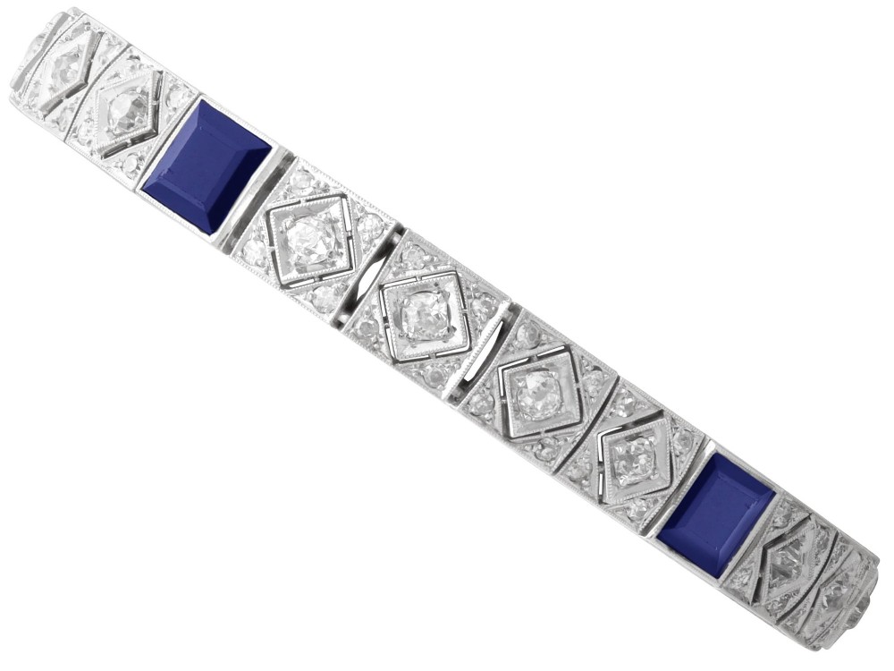 An Art Deco platinum bracelet featuring square basaltic blue sapphires and diamond-shaped link panels set with old-cut diamonds.