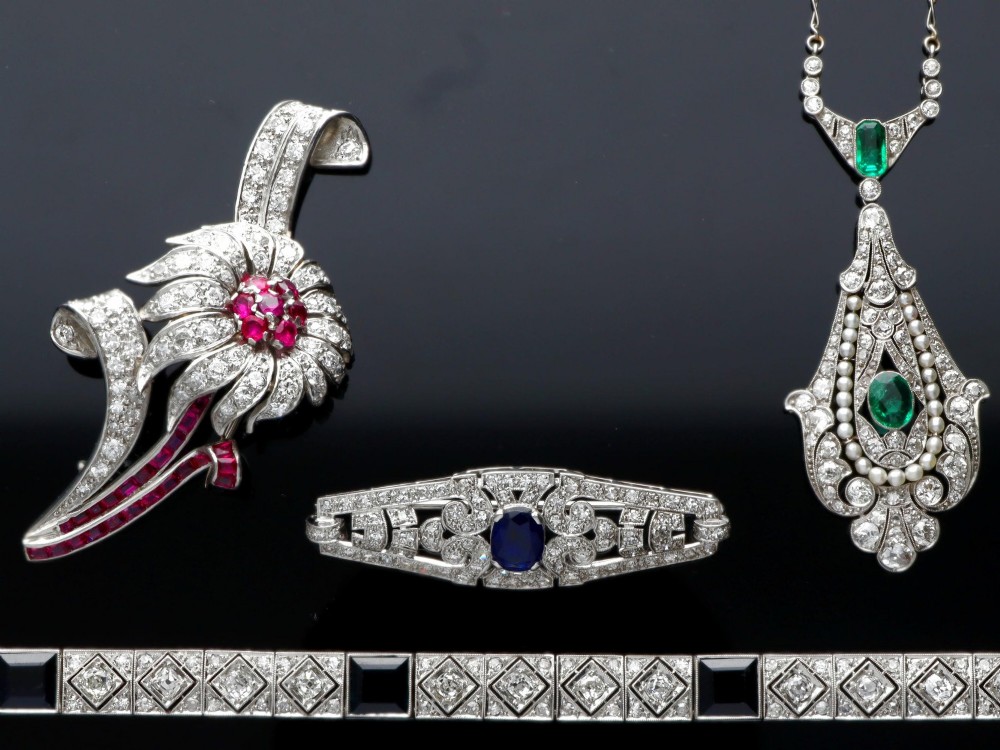 An Art Deco platinum bracelet featuring square basaltic blue sapphires and diamond-shaped link panels set with old-cut diamonds. View V