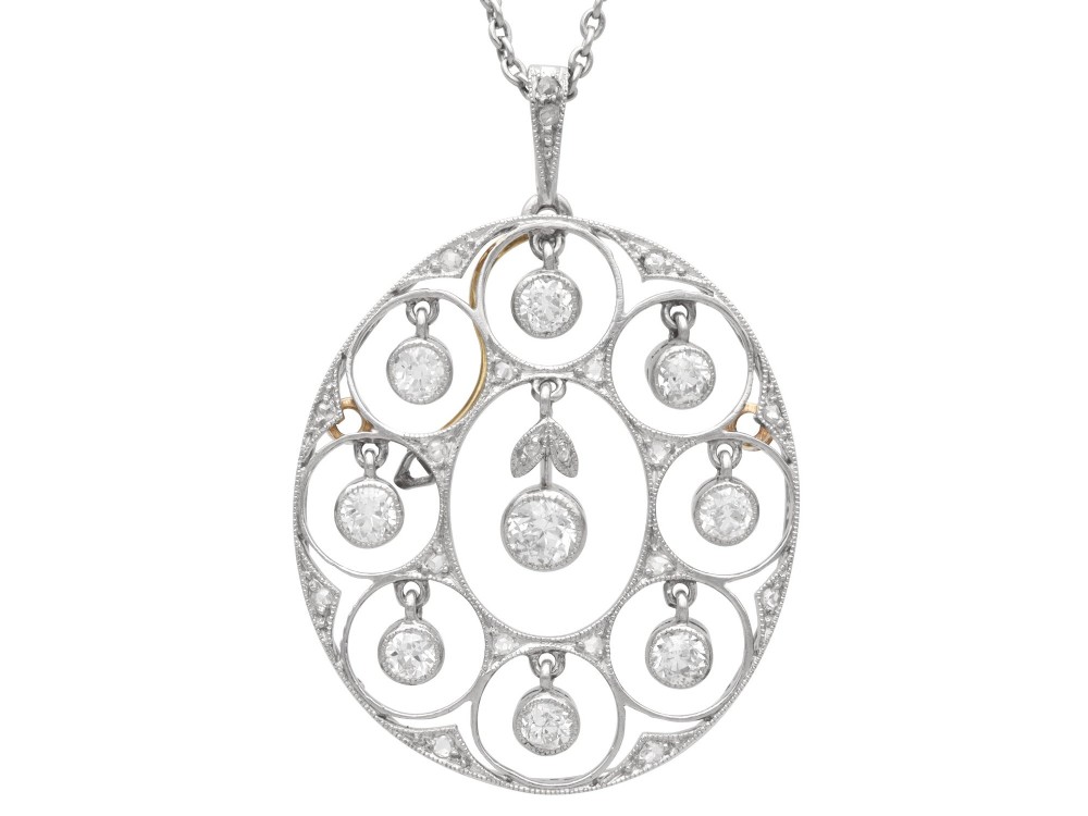An Art Deco circular platinum pendant featuring openwork wirework circles set with diamonds, suspended from a fine chain.