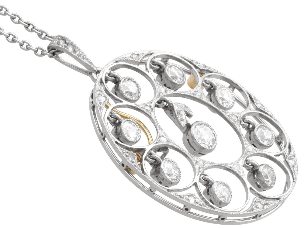An Art Deco circular platinum pendant featuring openwork wirework circles set with diamonds, suspended from a fine chain. View VI
