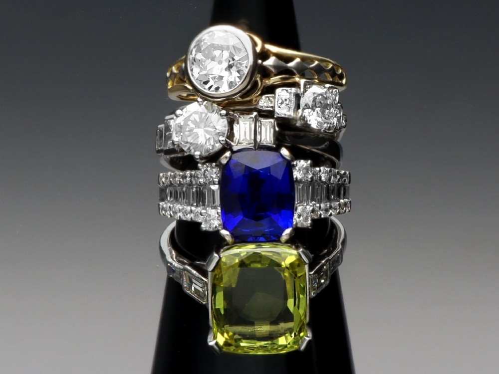 An 18ct white gold Art Deco ring featuring a central round diamond flanked by stepped baguette diamond shoulders. View III