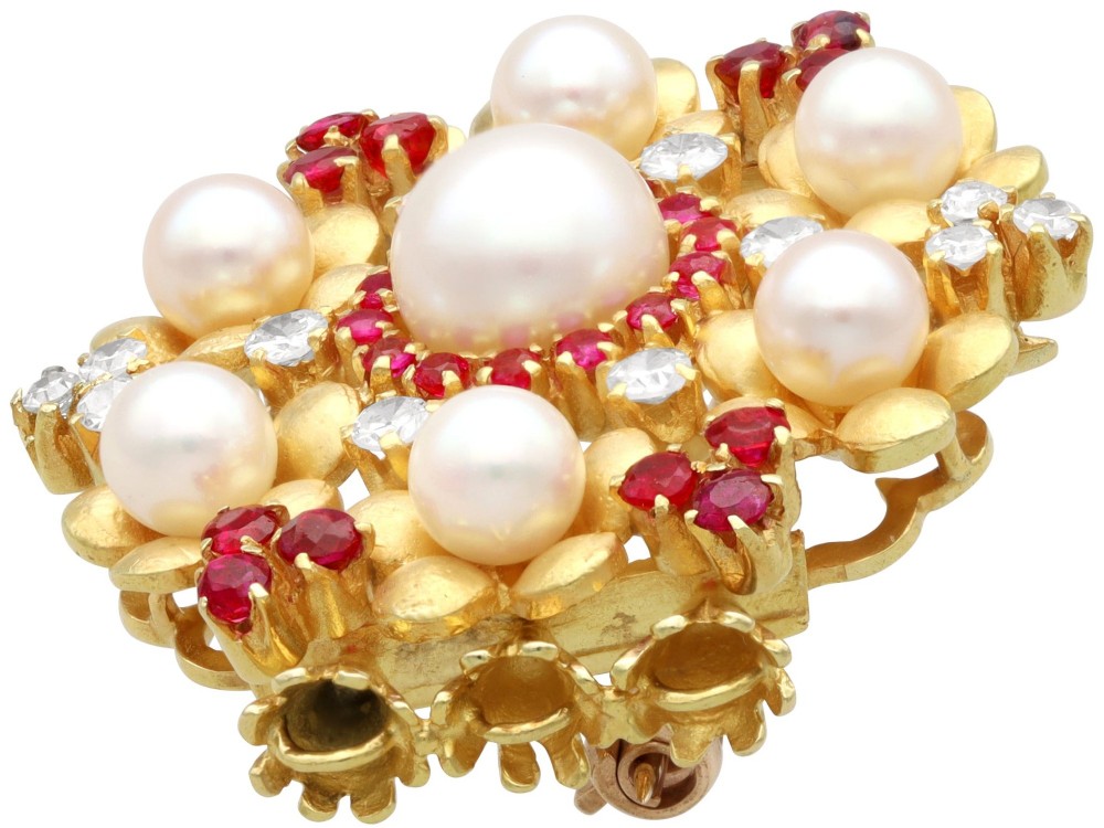 An 18ct yellow gold floral cluster brooch set with a central pearl surrounded by small rubies, outer cultured pearls, round diamonds, and red rubies. View VIII