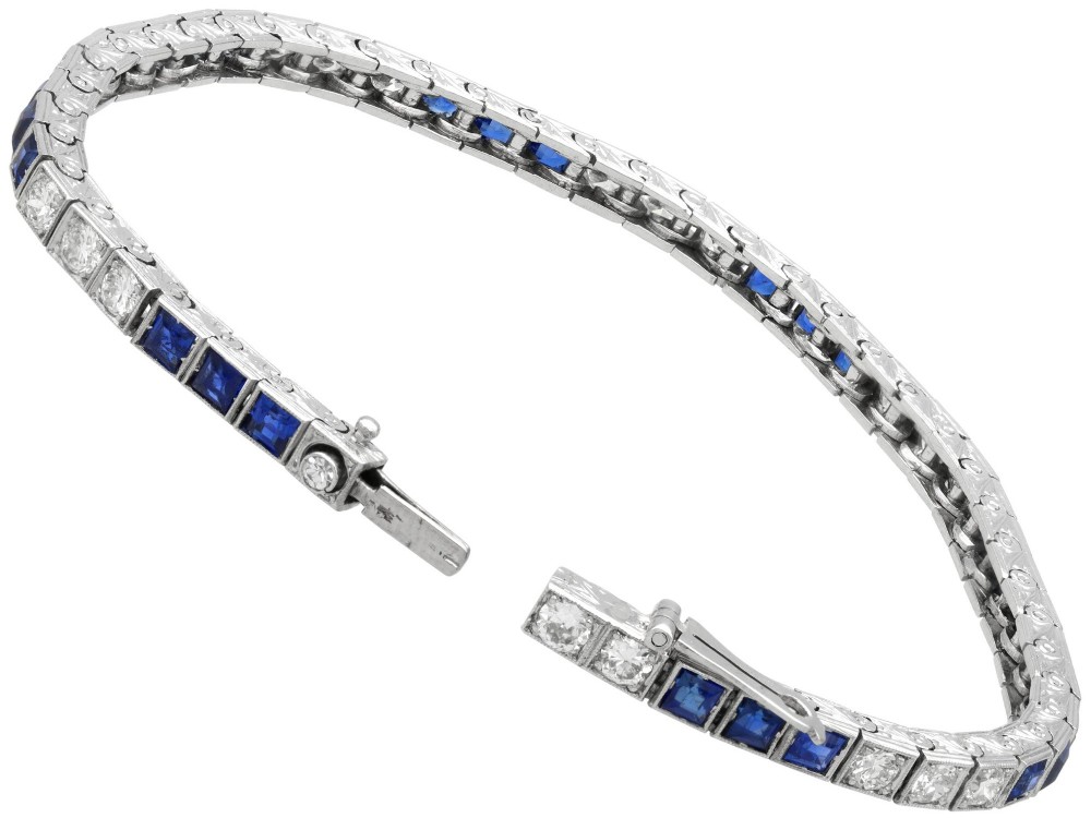 An Art Deco platinum line bracelet set with alternating square blue sapphires and round brilliant diamonds. View XI