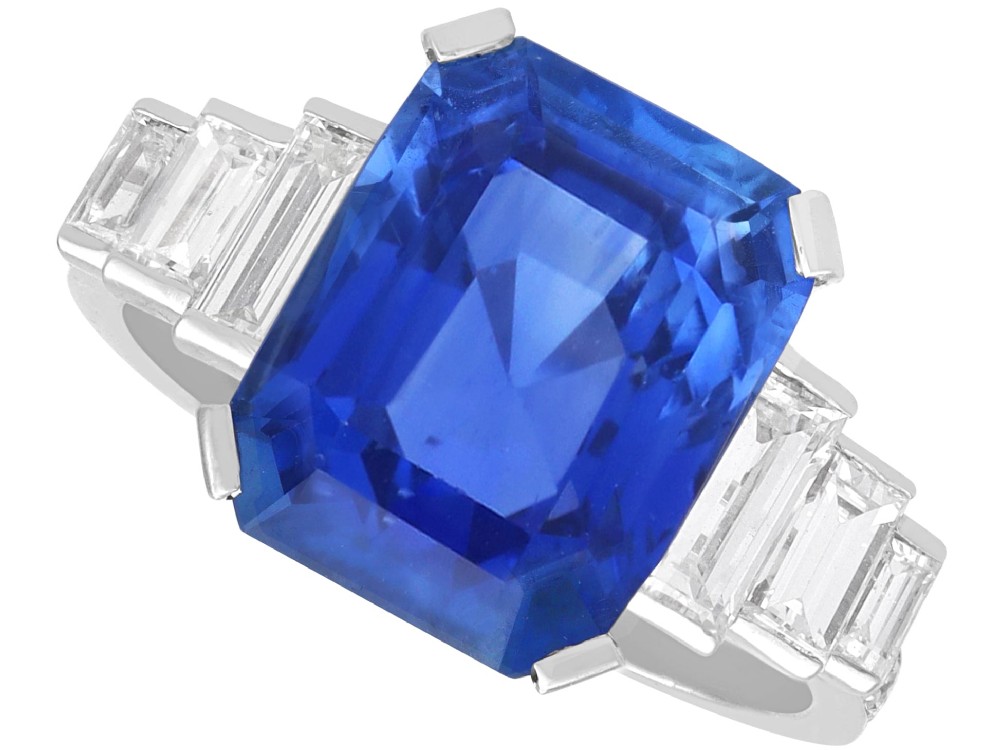 An emerald-cut blue sapphire ring set in platinum with stepped baguette diamond shoulders.