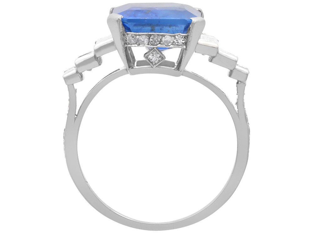 An emerald-cut blue sapphire ring set in platinum with stepped baguette diamond shoulders. View VI
