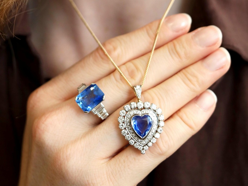 A heart-shaped 14ct yellow gold pendant featuring a central heart-cut Ceylon sapphire surrounded by a double halo of brilliant-cut diamonds. View III