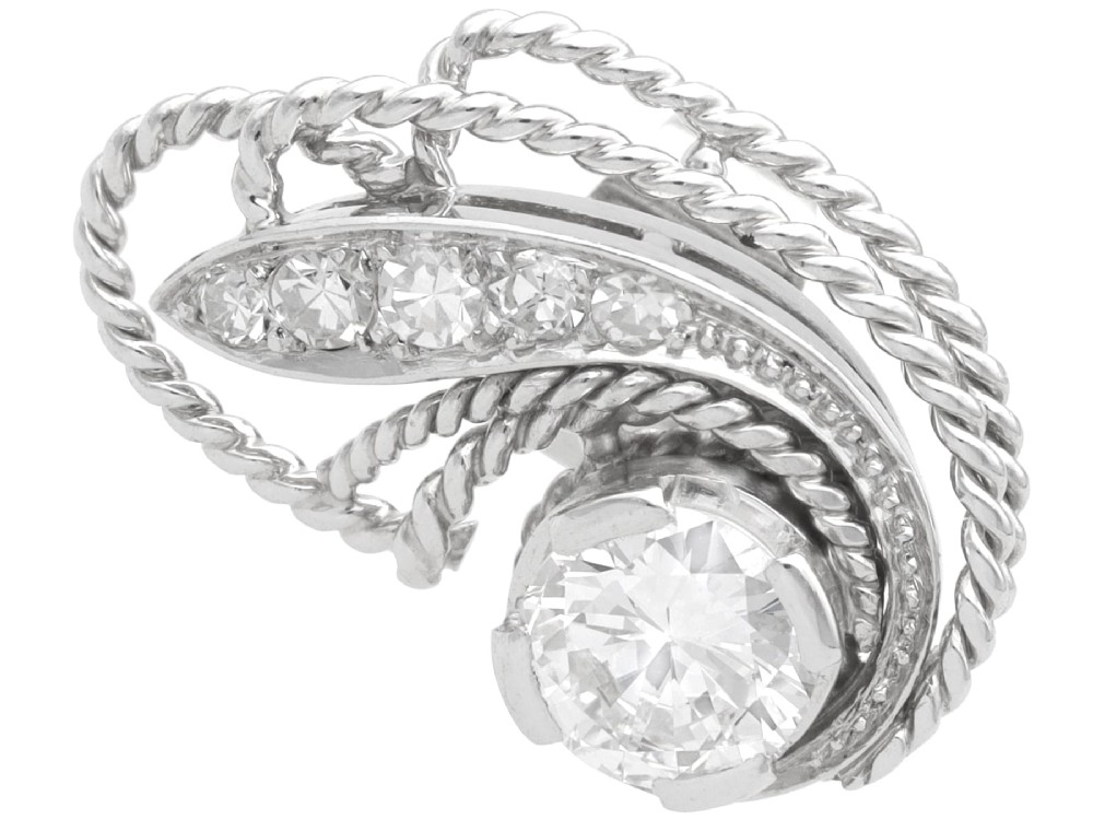 A pair of Art Deco platinum earrings featuring round diamonds set within a textured rope-twist swirl design. View IV