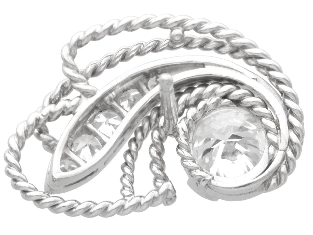 A pair of Art Deco platinum earrings featuring round diamonds set within a textured rope-twist swirl design. View V