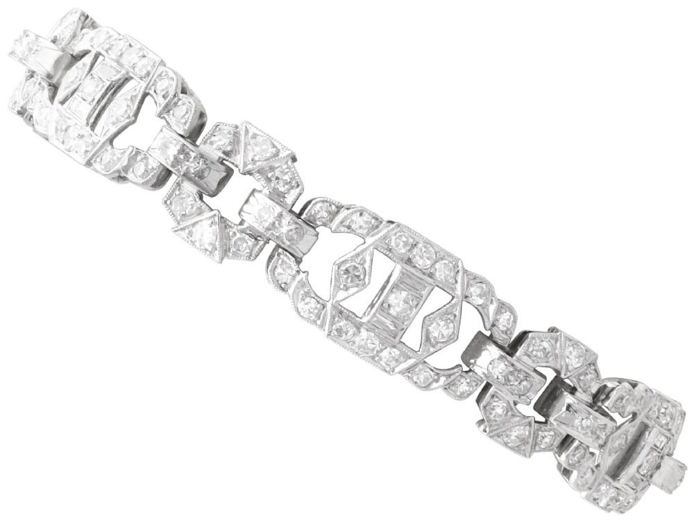 An Art Deco platinum bracelet featuring articulated geometric links set with brilliant-cut diamonds.
