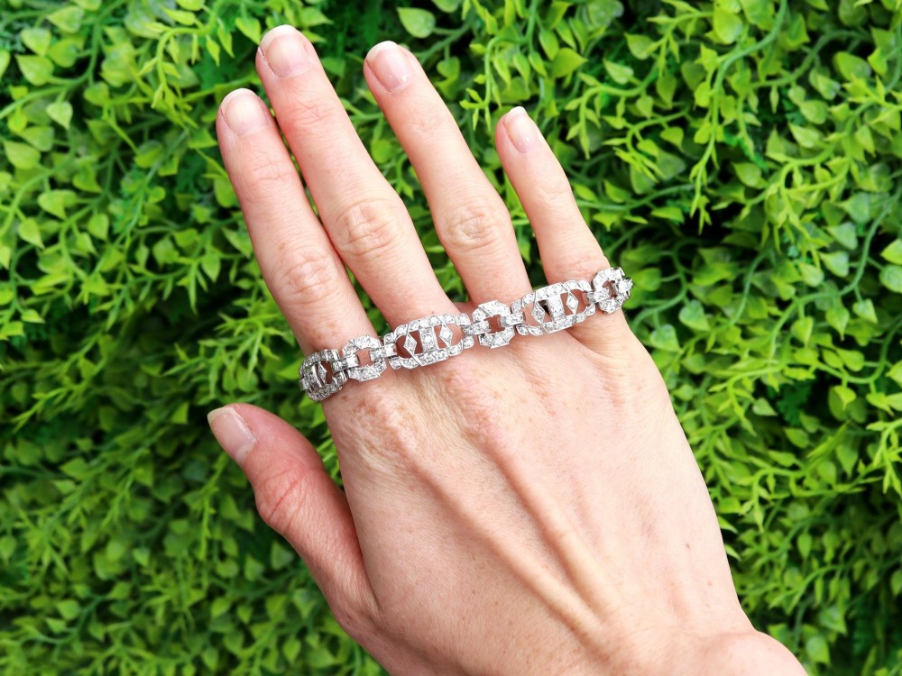An Art Deco platinum bracelet featuring articulated geometric links set with brilliant-cut diamonds. View II