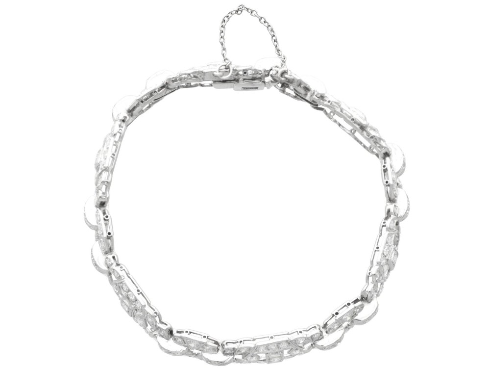 An Art Deco platinum bracelet featuring articulated geometric links set with brilliant-cut diamonds. View V