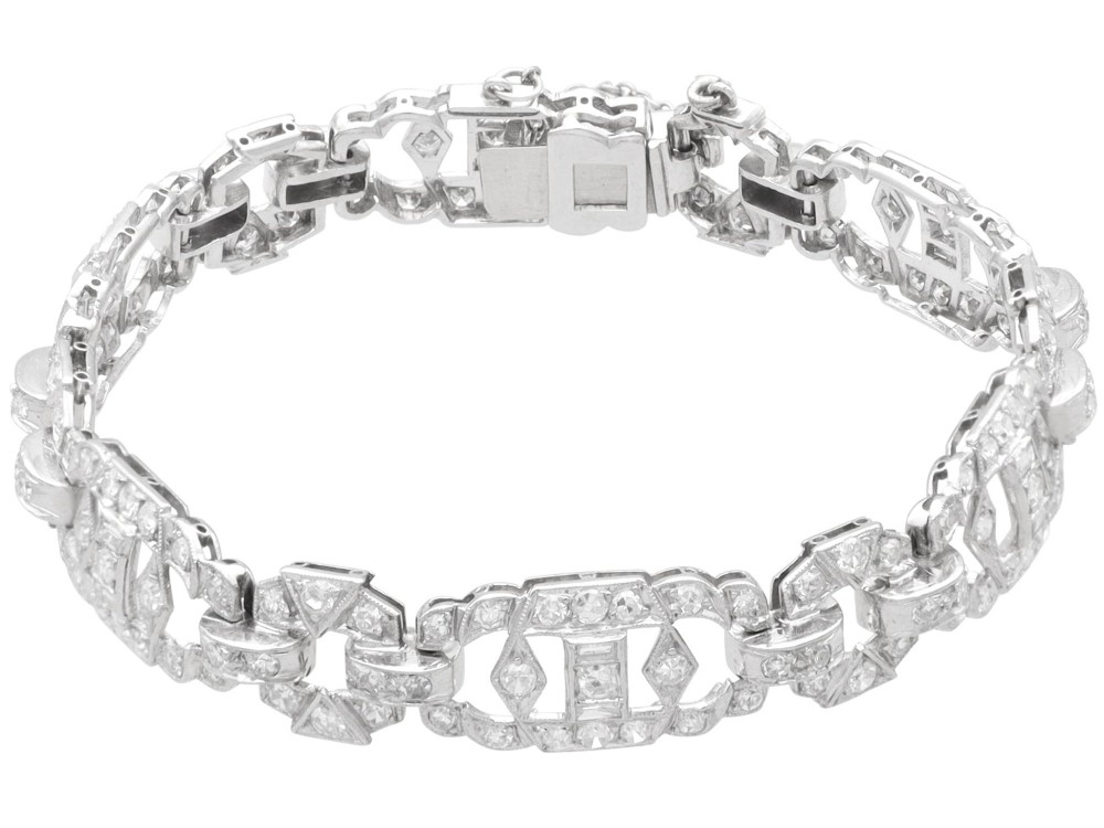 An Art Deco platinum bracelet featuring articulated geometric links set with brilliant-cut diamonds. View VI
