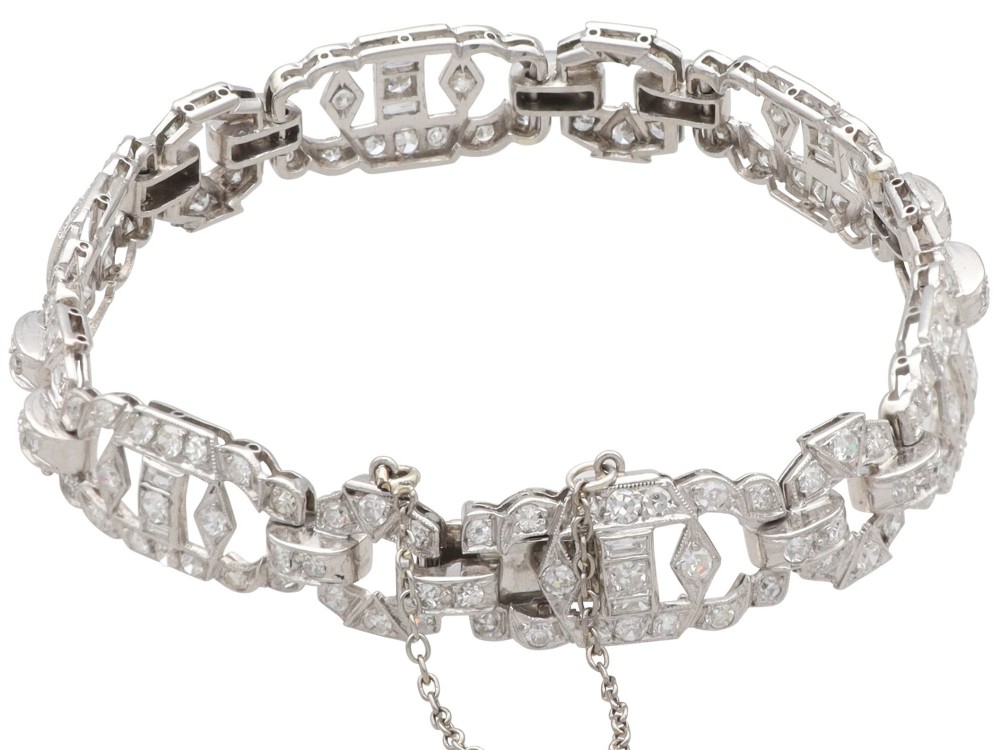 An Art Deco platinum bracelet featuring articulated geometric links set with brilliant-cut diamonds. View VII