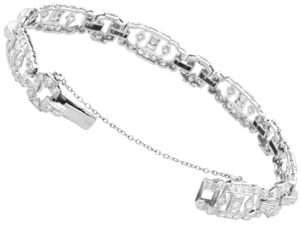 An Art Deco platinum bracelet featuring articulated geometric links set with brilliant-cut diamonds. View VIII