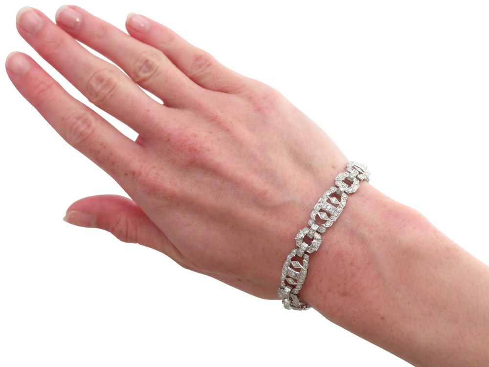 An Art Deco platinum bracelet featuring articulated geometric links set with brilliant-cut diamonds. View XI