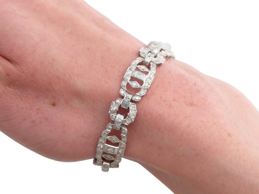 An Art Deco platinum bracelet featuring articulated geometric links set with brilliant-cut diamonds. View XII