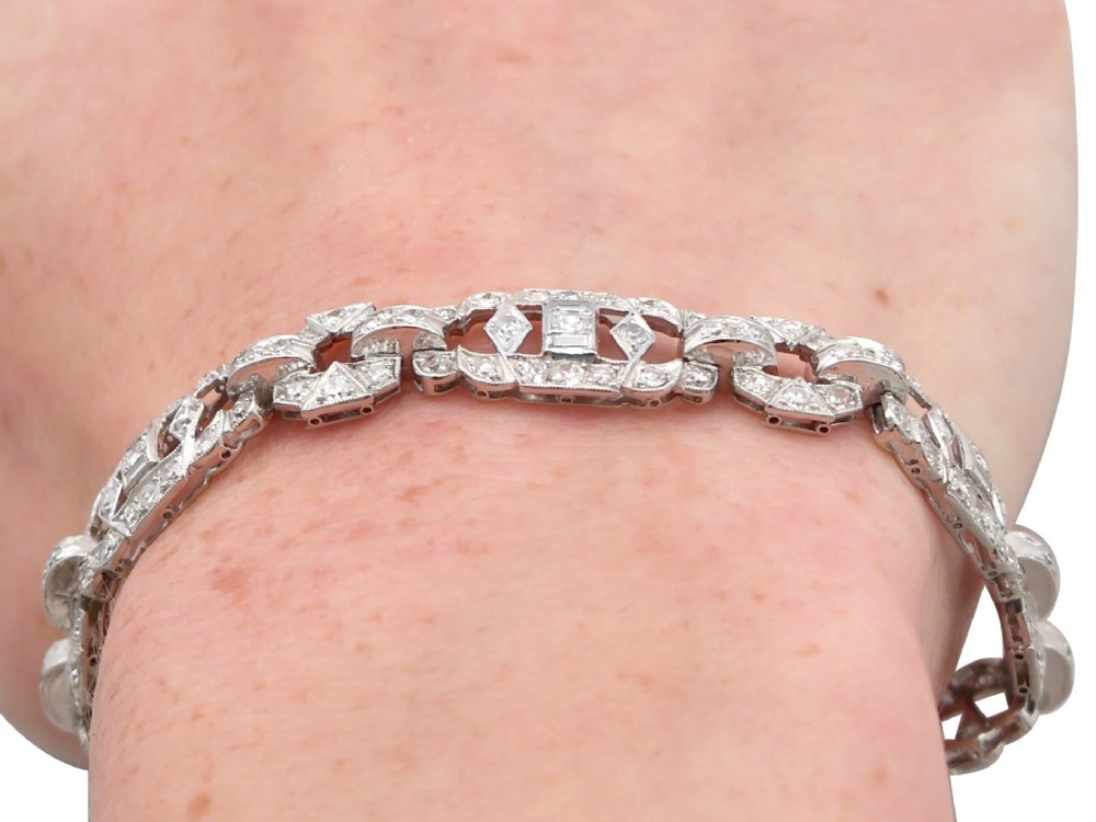 An Art Deco platinum bracelet featuring articulated geometric links set with brilliant-cut diamonds. View XIII