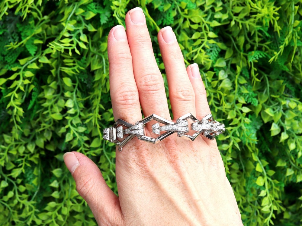 An Art Deco 18ct white gold link bracelet set with diamonds arranged in geometric openwork motifs. View II