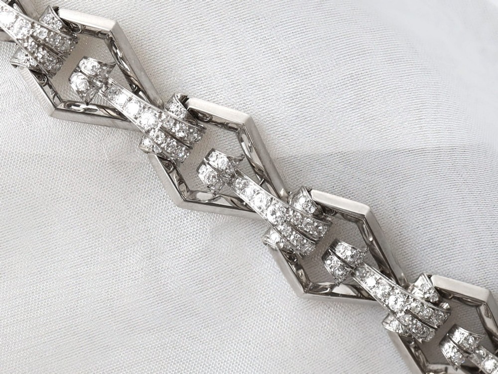 An Art Deco 18ct white gold link bracelet set with diamonds arranged in geometric openwork motifs. View VII