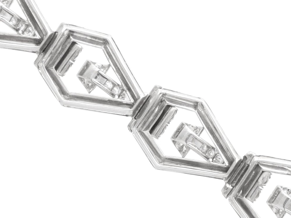 An Art Deco 18ct white gold link bracelet set with diamonds arranged in geometric openwork motifs. View X