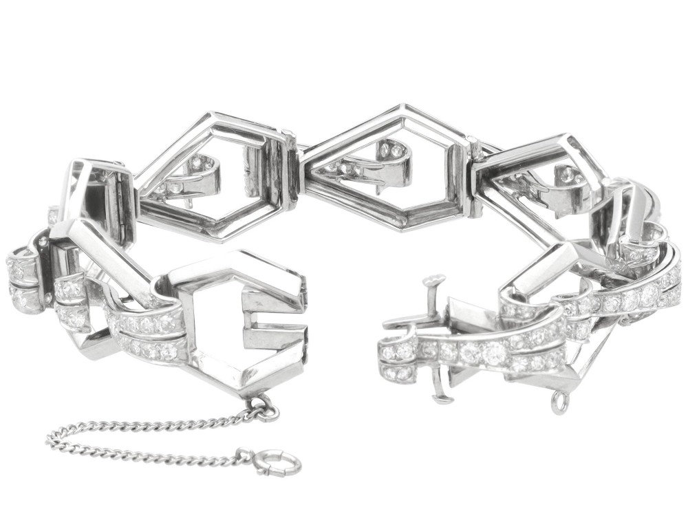 An Art Deco 18ct white gold link bracelet set with diamonds arranged in geometric openwork motifs. View XII