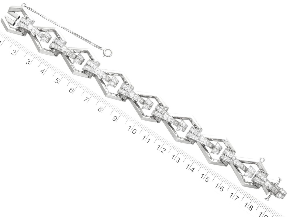 An Art Deco 18ct white gold link bracelet set with diamonds arranged in geometric openwork motifs. View XIII