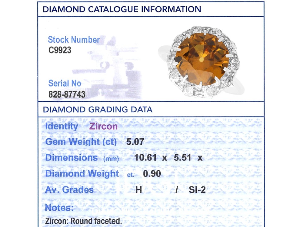 An antique Art Deco platinum ring featuring a central round orange zircon surrounded by a halo of claw-set diamonds. View XI