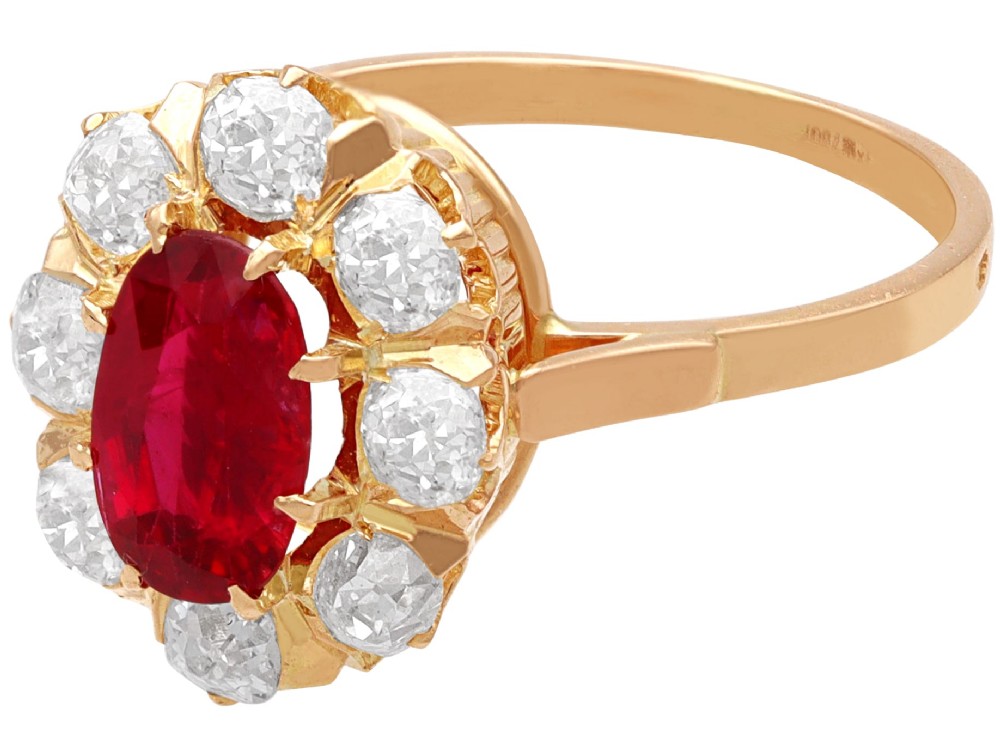 An 18ct rose gold cluster ring featuring a central oval red ruby surrounded by eight old cut diamonds set in individual claw settings. View VII