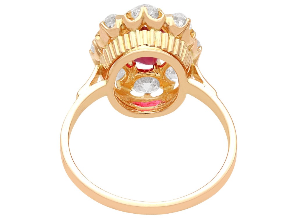 An 18ct rose gold cluster ring featuring a central oval red ruby surrounded by eight old cut diamonds set in individual claw settings. View VIII