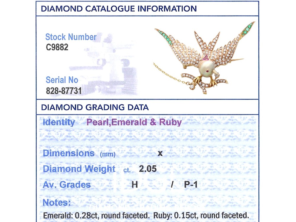 An antique Victorian 18ct yellow gold bird brooch set with diamonds on the wings, emeralds along the outer feathers, a natural pearl body, and ruby details. View X