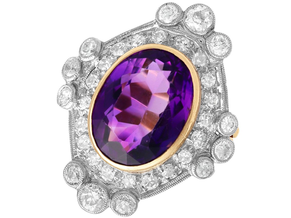 An Art Deco ring featuring a central oval purple amethyst set in yellow gold, framed by a millegrain diamond halo.